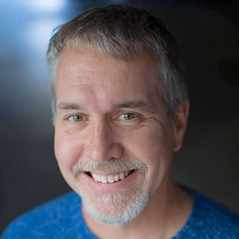 Portrait photograph of Loren Ybarrondo wearing a blue sweater.