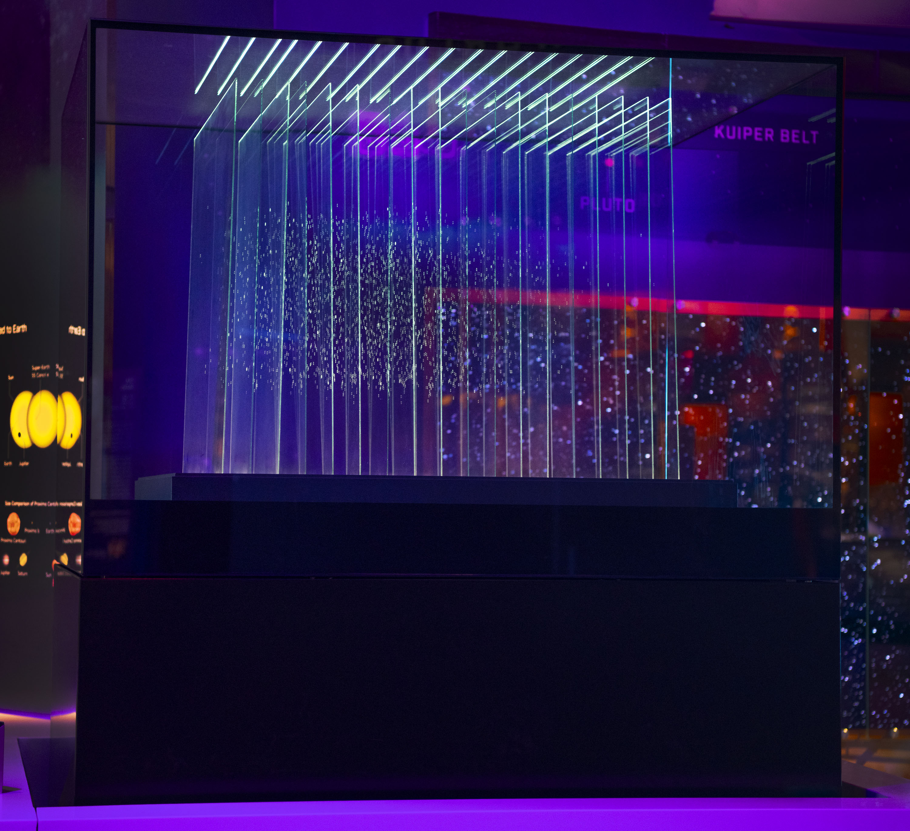 Glass sculpture made from eighteen upright panes engraved with dots representing stars and planetary systems.