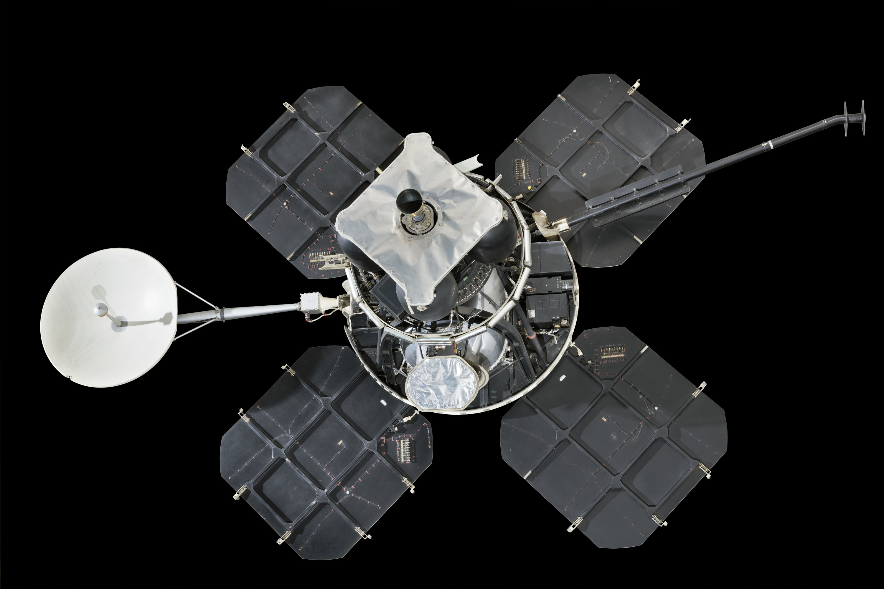 A black-and-silver lunar mapping spacecraft with four petal-like solar panels, central film-processing hardware, antennas, and camera equipment.