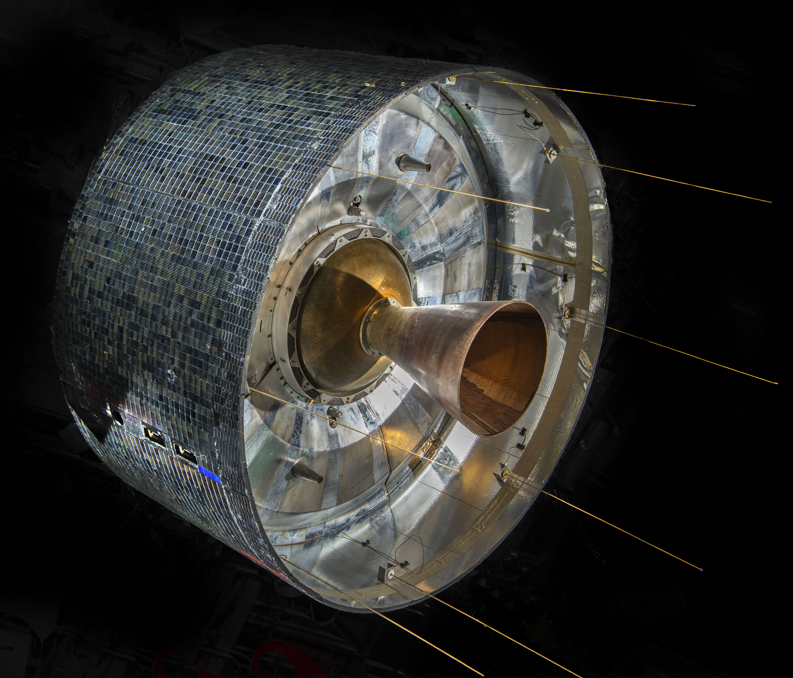 Cylindrical satellite covered with solar cells and fitted with whip antennas and a bell-shaped rocket motor.