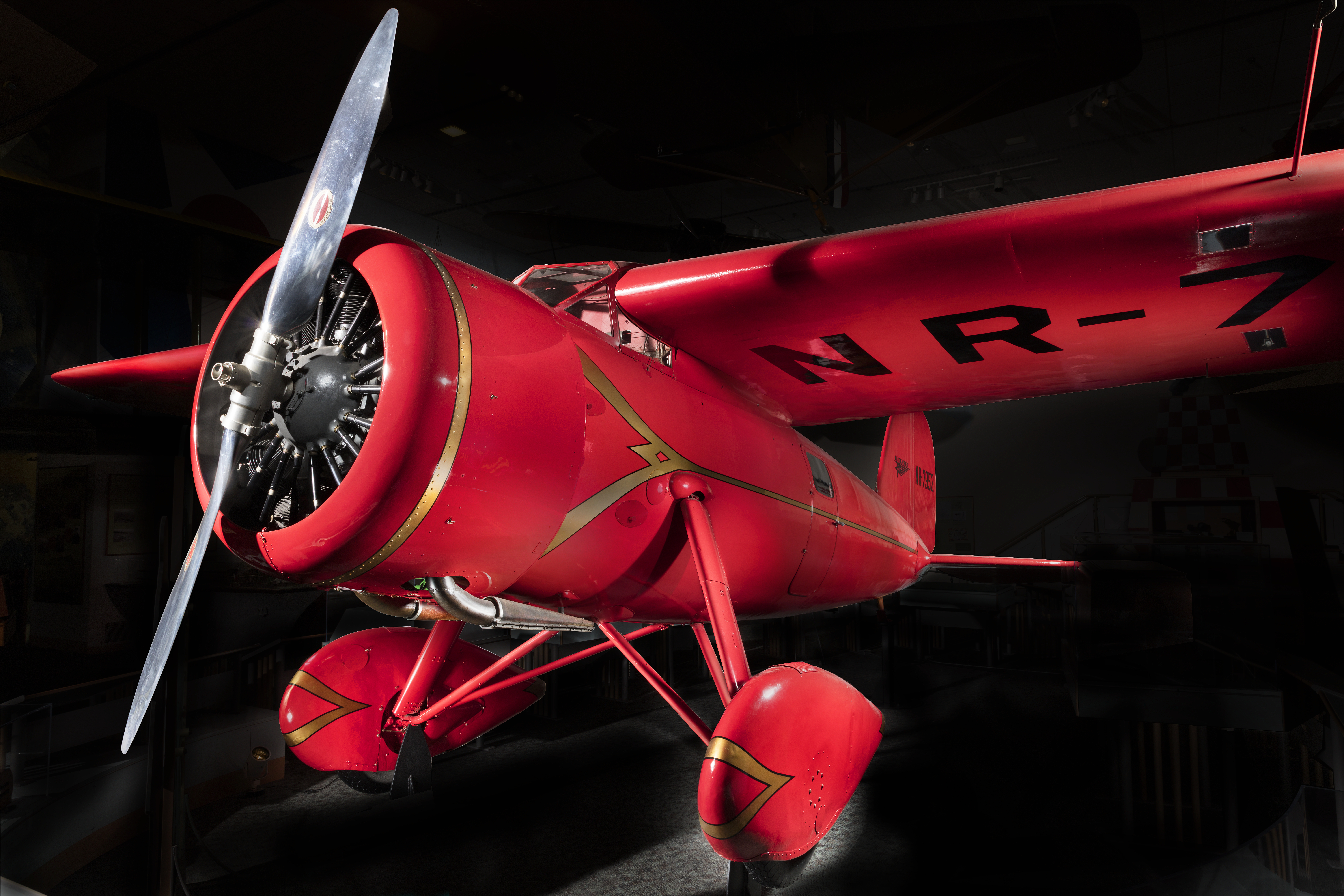 Bright red, streamlined Lockheed Vega monoplane with cantilever wings and tail number NR7952.