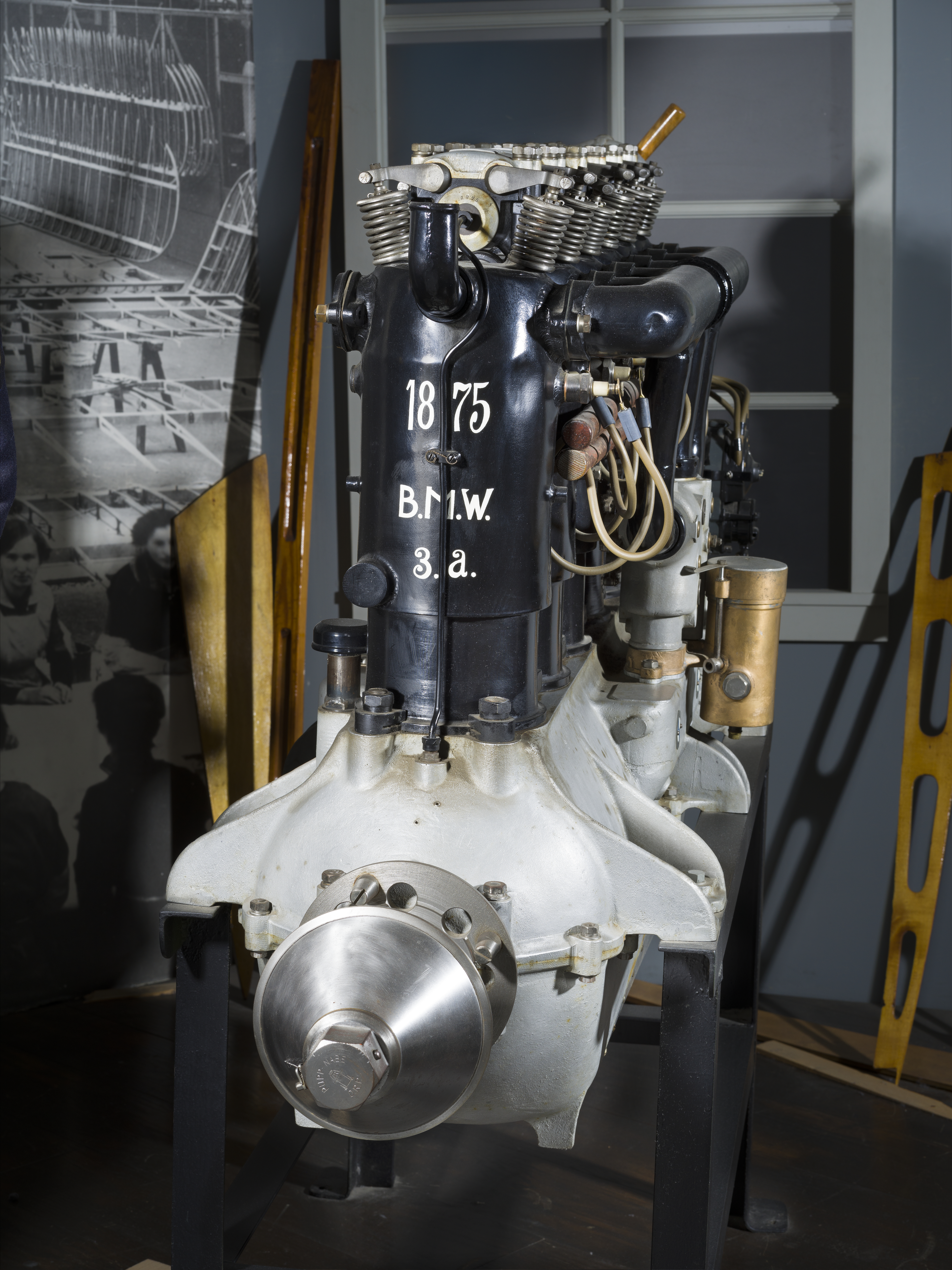 Long six-cylinder BMW inline aircraft engine with exposed metal components and BMW emblems.