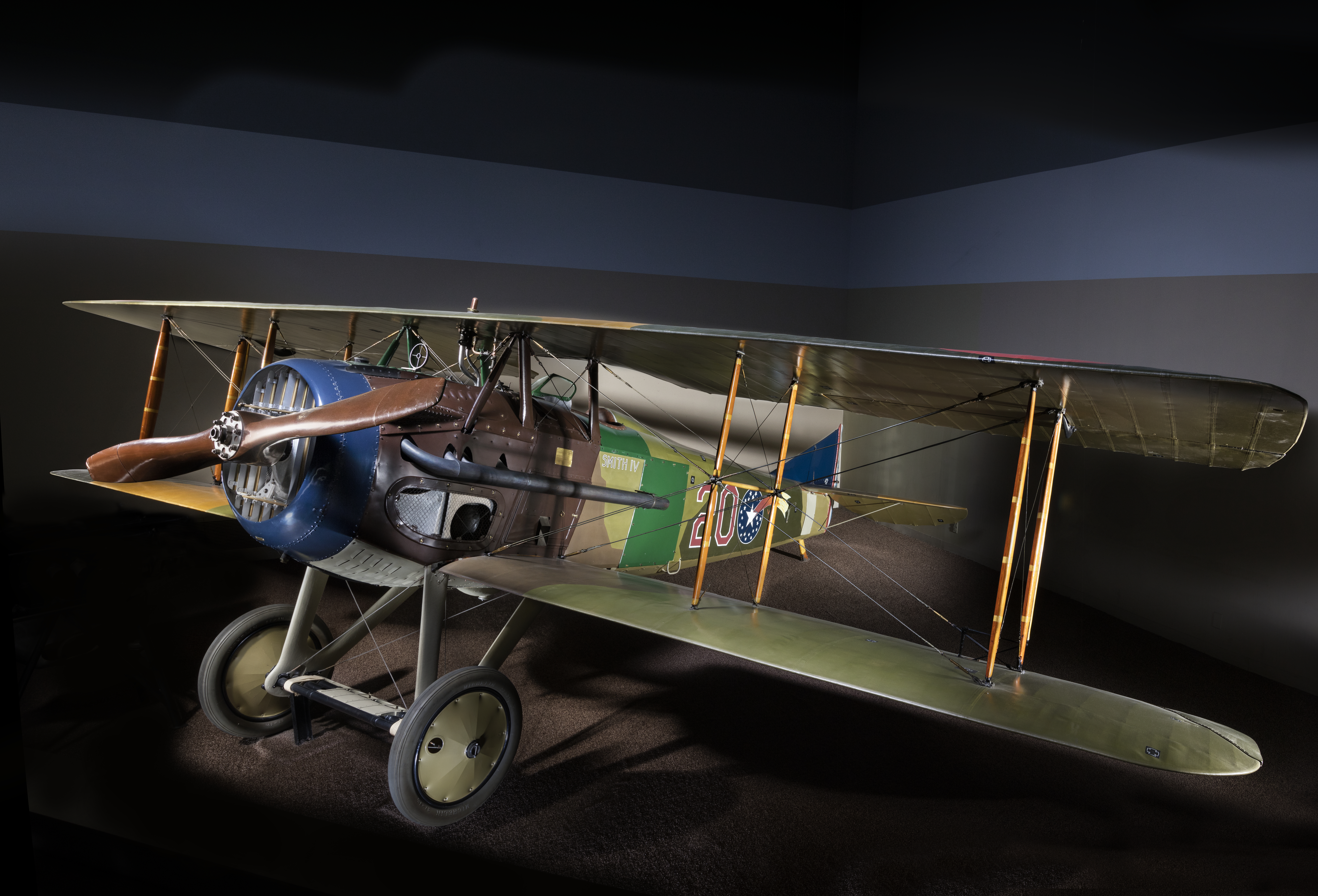 French-built SPAD XIII biplane fighter in green and brown camouflage with gray undersides.