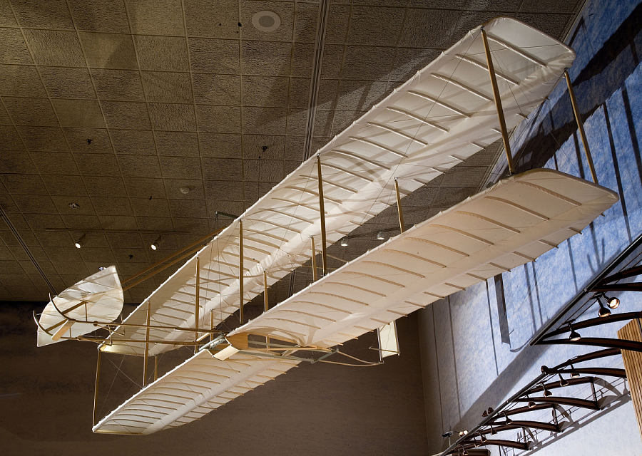 Fabric-covered biplane glider with long narrow wings, forward elevator, wing warping, and a movable vertical tail.