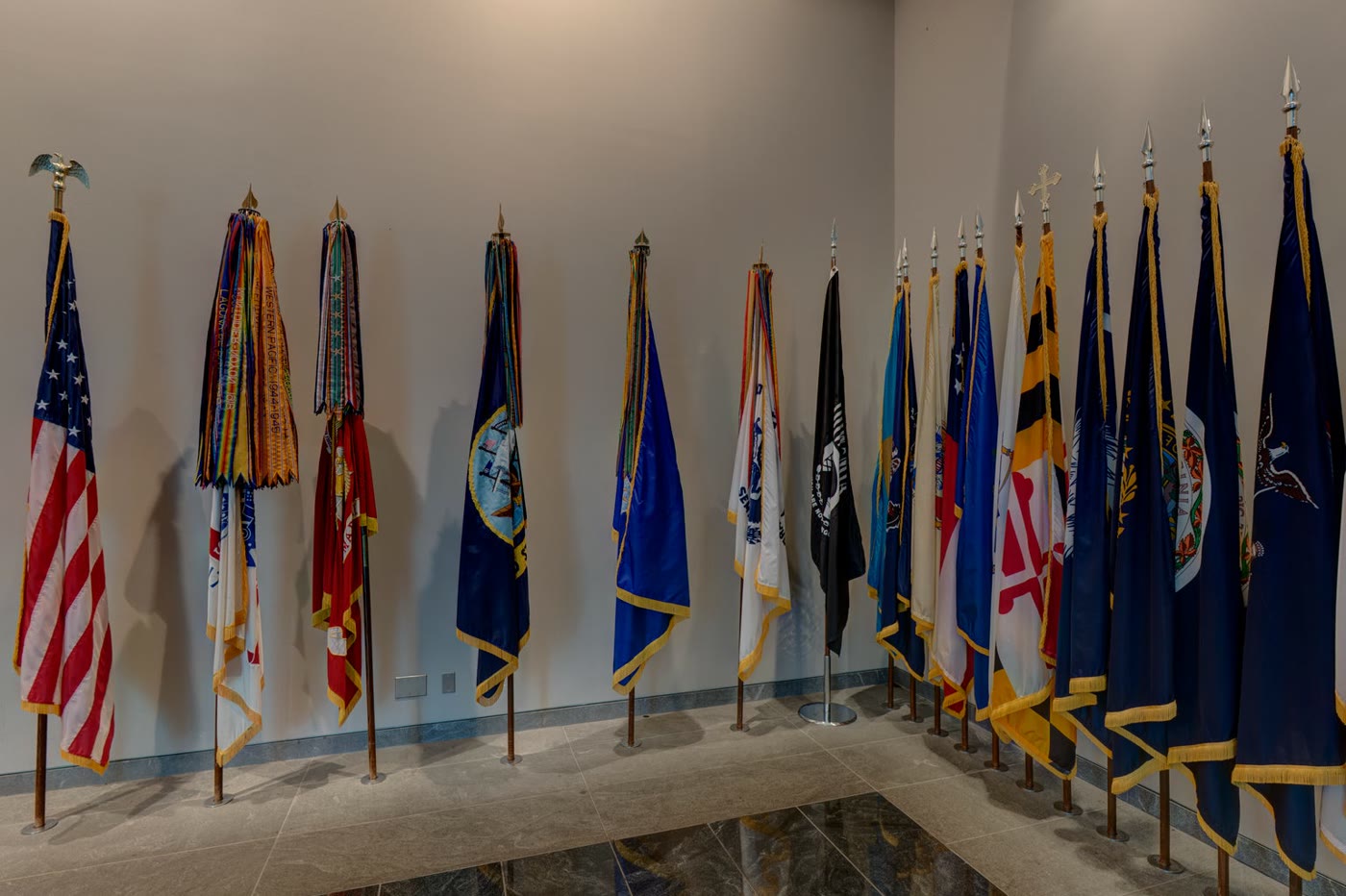Service, state, and organizational flags gathered inside the memorial