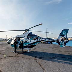 A helicopter and crew on the landing pad at Metro Aviation in Shreveport